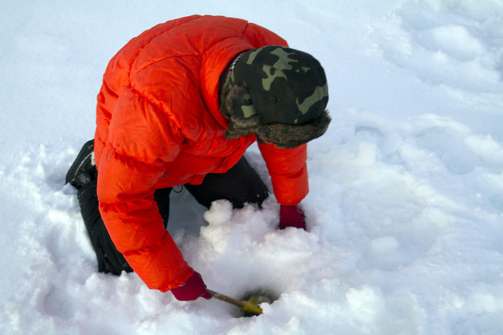 Removing ice and snow obstructing the hole