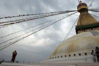 Buddhist monk helping usher people off the stupa for closing.