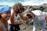 French girls bite the neck of a fish before tossing it in the cooler